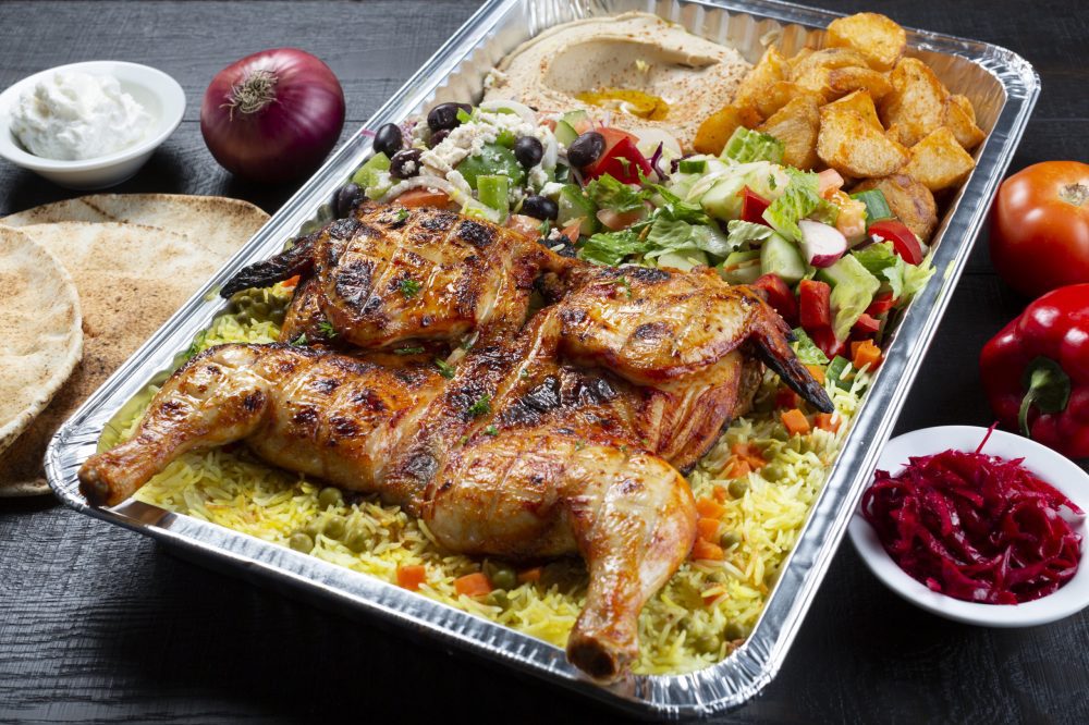 Roasted chicken tray with rice, salad, hummus and potatoes